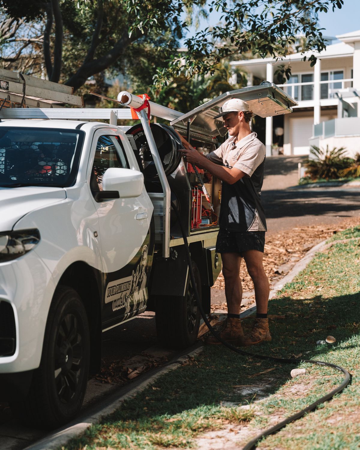 Mason loading gear into the Your Relining Mates ute